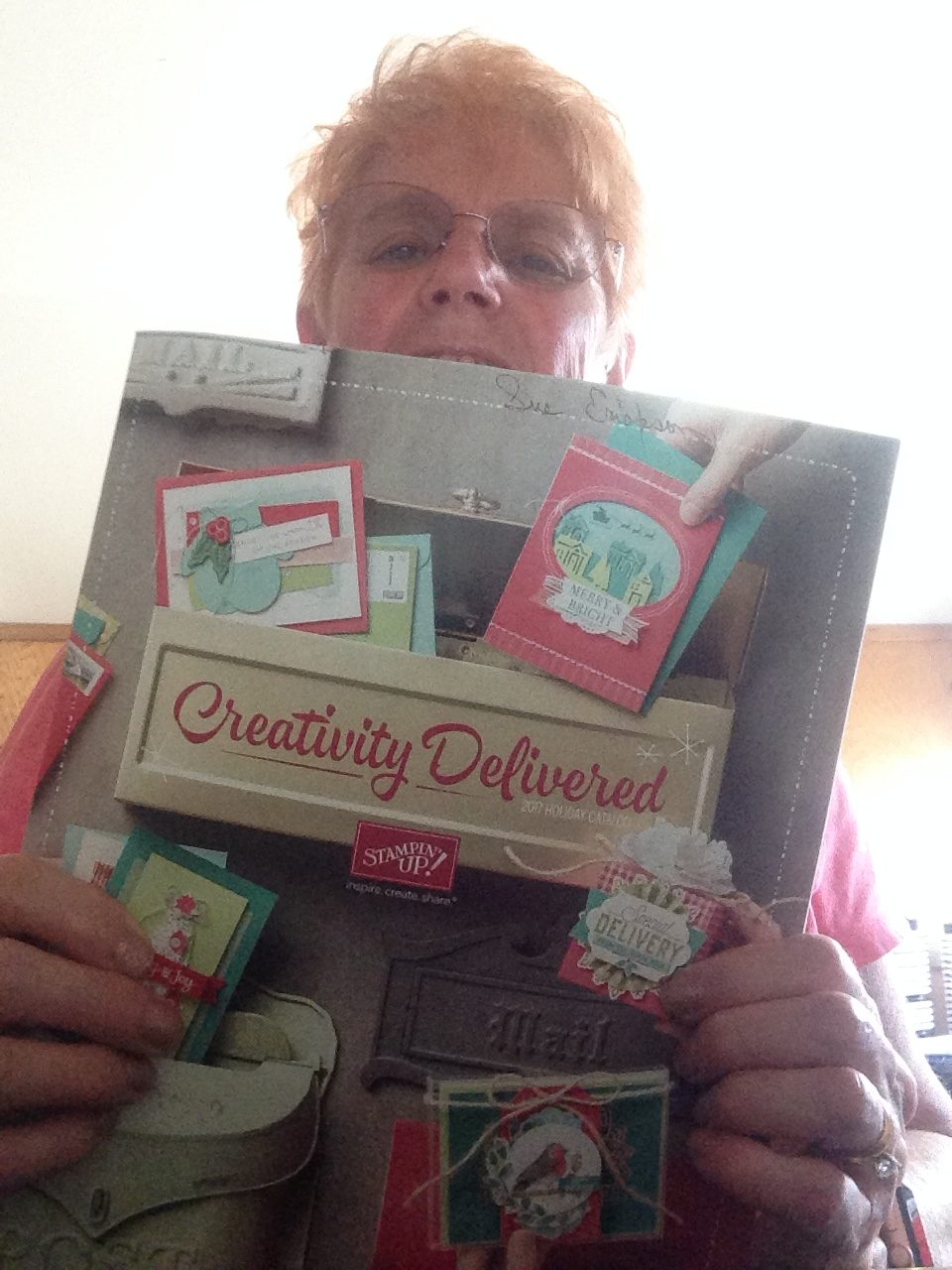 Sue holding the holiday catalog